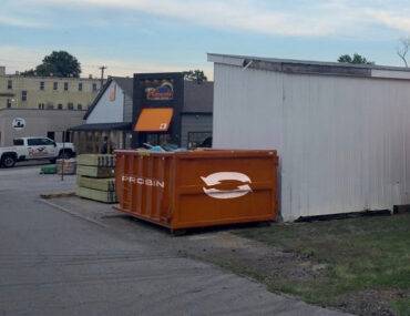 a dumpster next to a building