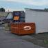 a dumpster next to a building